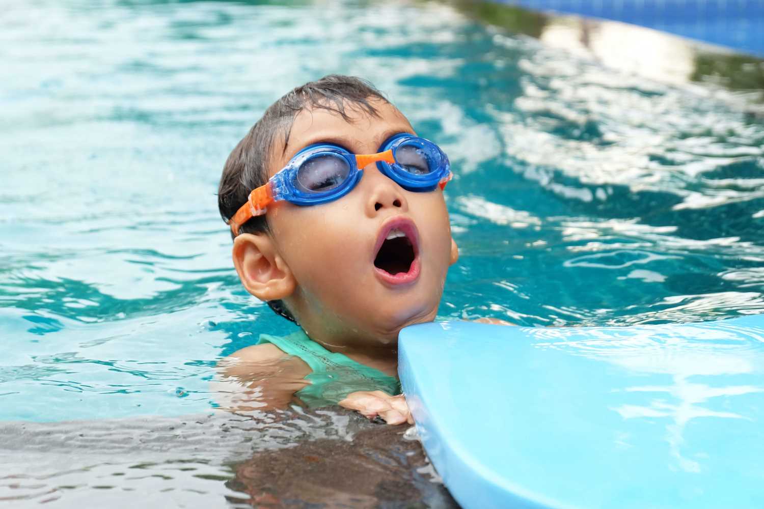 boy swimming with flotation device